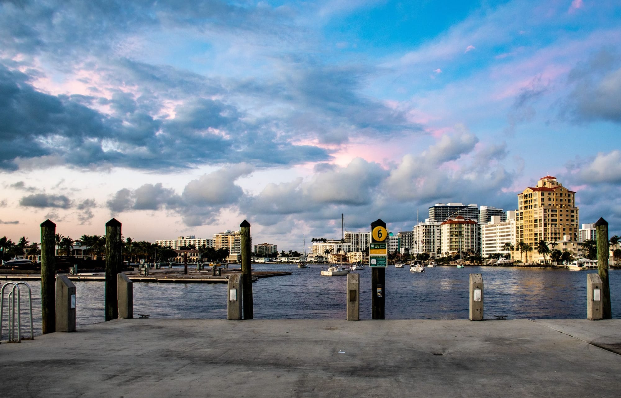 Docks and waterfront towers under an evening sky